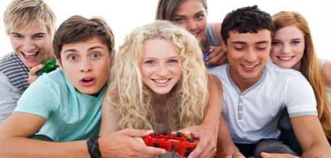 A group of teens playing video games together.