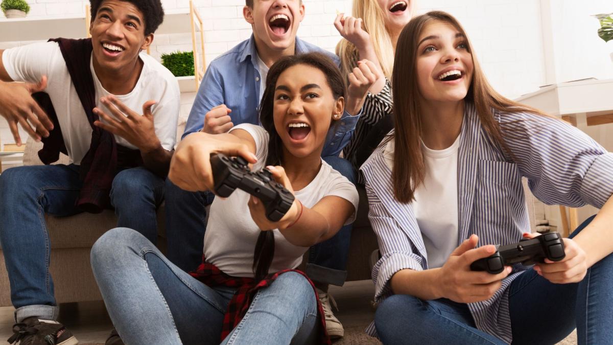 A group of teens playing video games together.