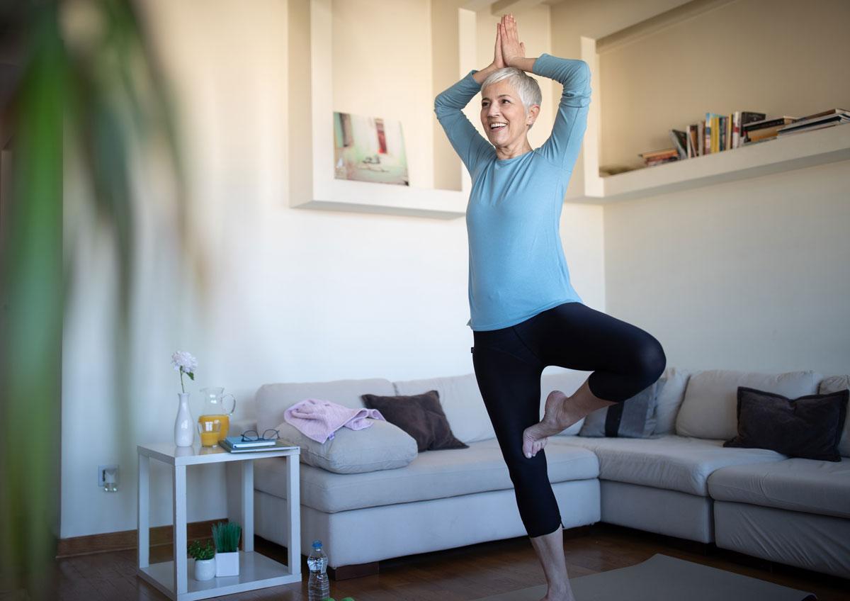 A woman balancing in a yoga pose.